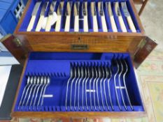 An oak table top cutlery canteen and contents (some pieces missing)