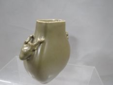 A small Chinese dark green vase decorated with two deer heads to the sides and having six