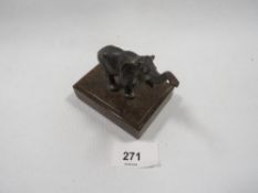 A small bronze figure of a baby elephant with a raised trunk on a marble base