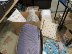 Three boxes of decorative cushions and throws etc