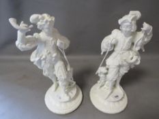 A pair of early 20th century cast metal figures depicting men in period costume with their dogs, lat