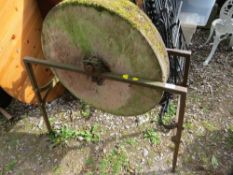 An antique grindstone and stand