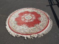 A large circular Chinese rug - Dia. 230 cm