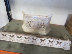 A vintage cast iron fire grate front