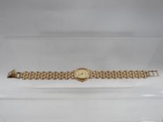 A hallmarked 9 carat gold Accurist wrist watch with stone set to dial at 12 o' clock approx.