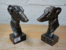Two cast greyhound heads **