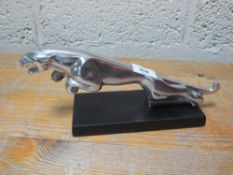 A polished aluminium Jaguar plaque **