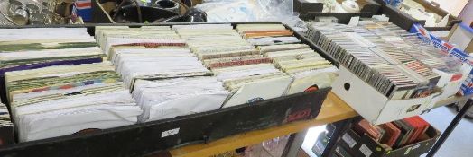 Two trays of cd's together with a tray of 45's