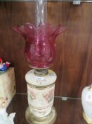 A vintage ceramic oil lamp with cranberry style shade -top loose