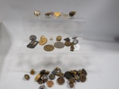 A small box of military badges and buttons etc