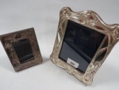 A modern hallmarked silver easel back photo frame with Art Nouveau design together with a smaller