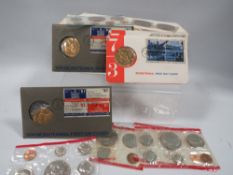 A collection of vintage US coin sets and medallions
