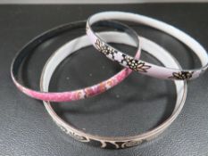 Two Michaela Fray enamel bangles together with a similar unmarked example (3)