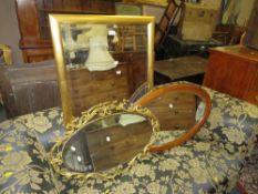 Three wall mirrors to include a modern rectangular framed example and an oval mahogany frame example