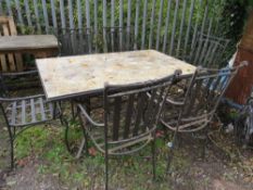 A stone tiled garden table set with 6 carver style chairs