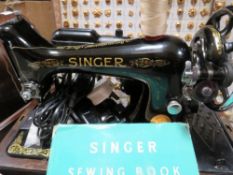 A cased Singer sewing machine Y9635075 and accessories