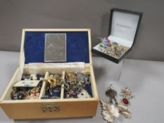 A box of costume jewellery together with selection of brooches