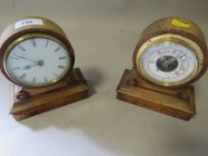 A small wooden mantle clock a with a matching barometer