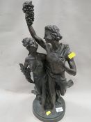 A large bronze effect figure of a couple with damage to arm