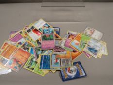 A box of Pokemon playing cards - some holographic