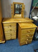 A modern honey pine dressing table with mirror and four drawer chest