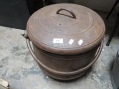 A cast iron cauldron with lid