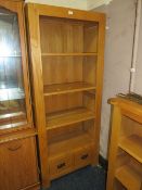 A modern open light oak bookcase with two drawers below H 180 cm W 75 cm
