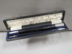 A cased hallmarked silver ebonised two piece conductors baton