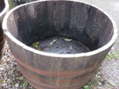 A very large half barrel oak garden planter