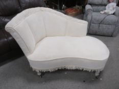 A shaped upholstered small chaise longue