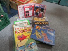 Three trays of assorted vintage books together with a quantity of postcard albums (postcards stuck