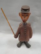 A novelty carved comical treen figure of a hiker