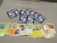 A box of Pokemon playing cards - some holographic