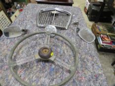 A chrome Wolseley grill and various vintage car parts to include mirrors, lights, steering wheel