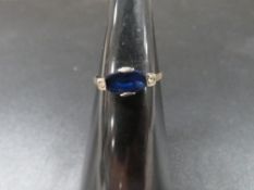 A ring set with blue stone marked 9ct approx. weight 1.1g
