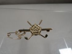 A hallmarked 9 carat gold golfing themed brooch approx. weight 3.9g