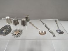 A small collection of silver thimbles, fob medals and salt spoons