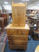 A honey pine five drawer chest together with a two door light oak cabinet. (2)