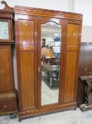 An Edwardian mahogany in laid mirrored wardrobe