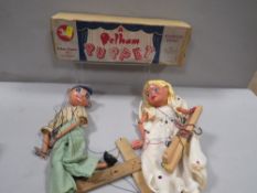 A vintage boxed Pelham puppet together with another