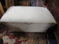 An antique upholstered ottoman