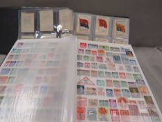 A collection of stamps and regiment silks