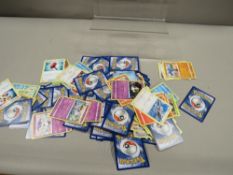 A box of Pokemon playing cards - some holographic