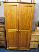 A modern honey pine double wardrobe