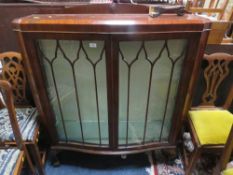 An early 20th century mahogany display cabinet - one loose leg