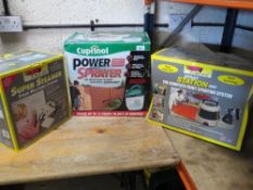 Three boxed items to include a cordless Cuprinol fence sprayer, and Earlex spray station and an