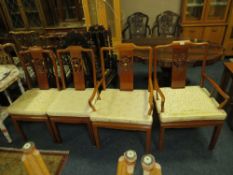 A set of four eastern style hardwood dining chairs