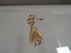 A brooch in the form of a lady golfer stamped 9ct approx weight 5.8g