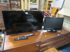 A JVC 31” flatscreen tv together with a smaller Logik example - remotes - House Clearance
