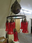 An unusual Moroccan style ceiling chandelier / light fitting with red glass shades (two loose in
